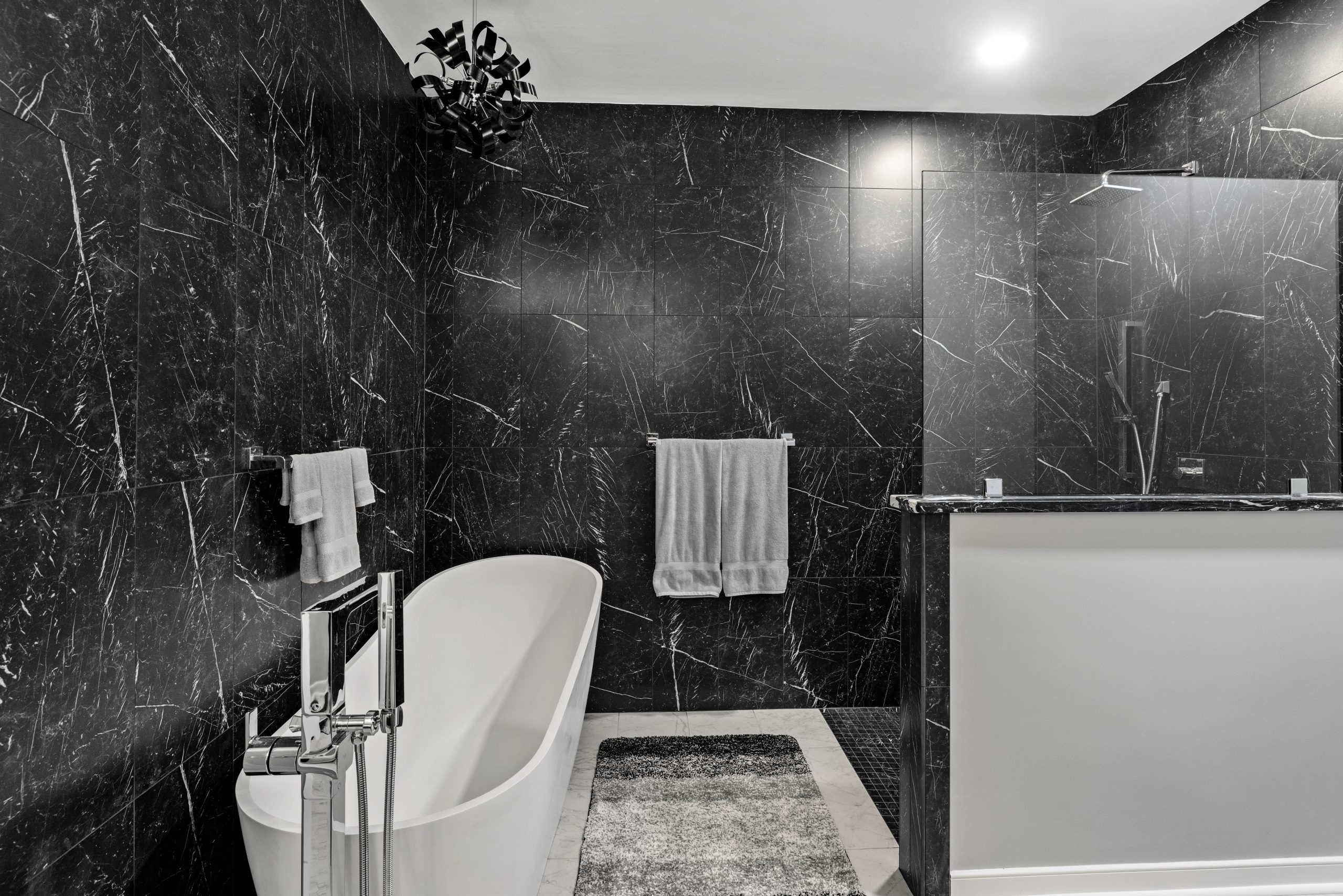 modern bathroom with black walls and walk in shower